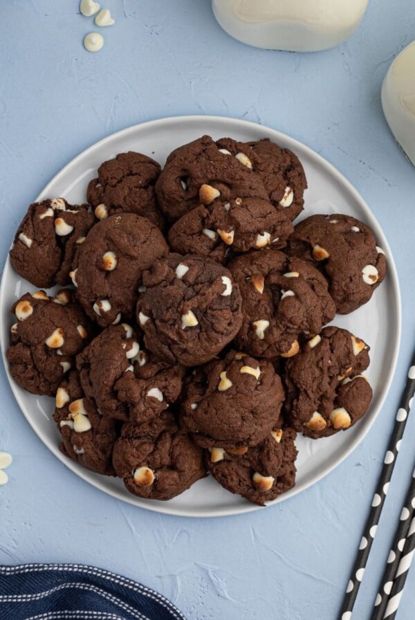 Chocolate Cookies with white baking chips, stacked on a plate. Chewy and moist air fryer cookies.