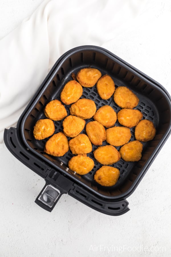 Chicken Nuggets in Air Fryer basket in a single layer ready to be cooked. 