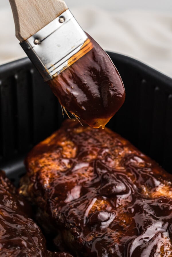 AIr Fryer BBQ Ribs with extra sauce being added.