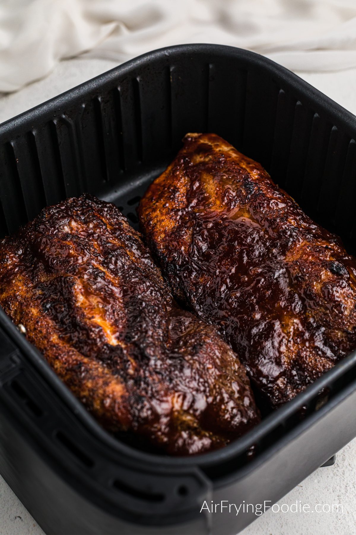 BBQ sauce on ribs in the air fryer.