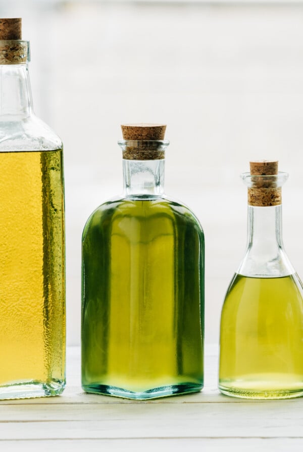 Different oils in bottles on a counter top.