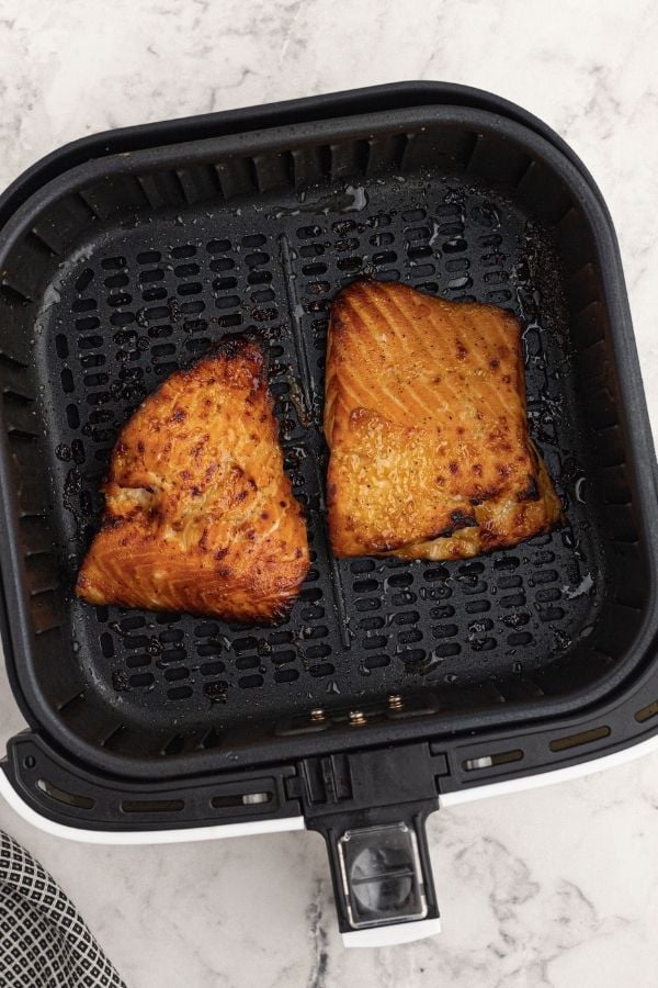 Cooked glazed honey mustard salmon, in the air fryer basket. 