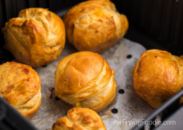 Cooked Biscuit Bombs in the basket of the Air Fryer. 