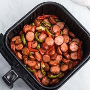 Sausage and peppers in an Air Fryer basket.