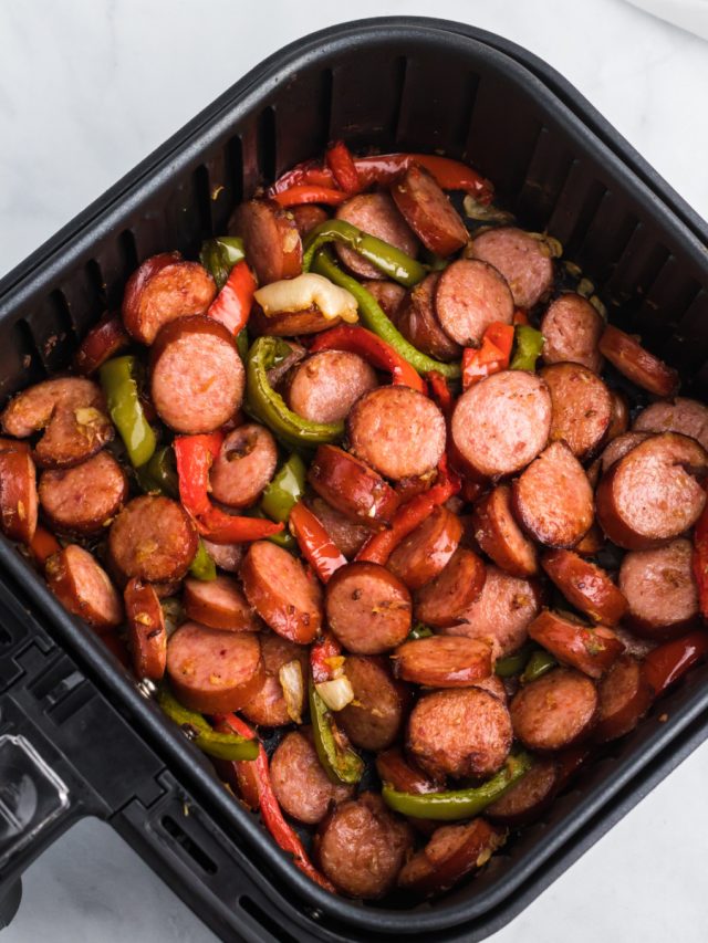 Sausage and peppers in an Air Fryer basket.