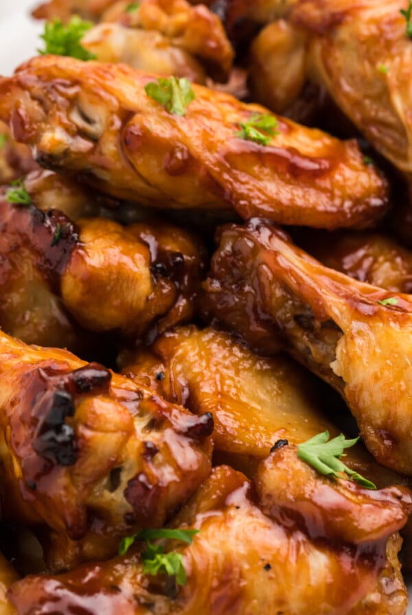 BBQ Chicken Wings stacked on a white serving tray that have been cooked in the Air Fryer.