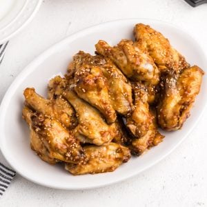 Air Fryer Honey Garlic Chicken Wings on a white serving dish ready to serve.