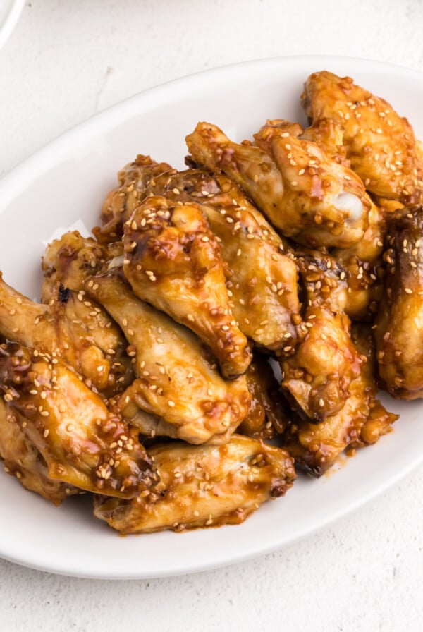 Air Fryer Honey Garlic Chicken Wings on a white serving dish ready to serve.