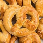 Golden soft pretzels on a white plate