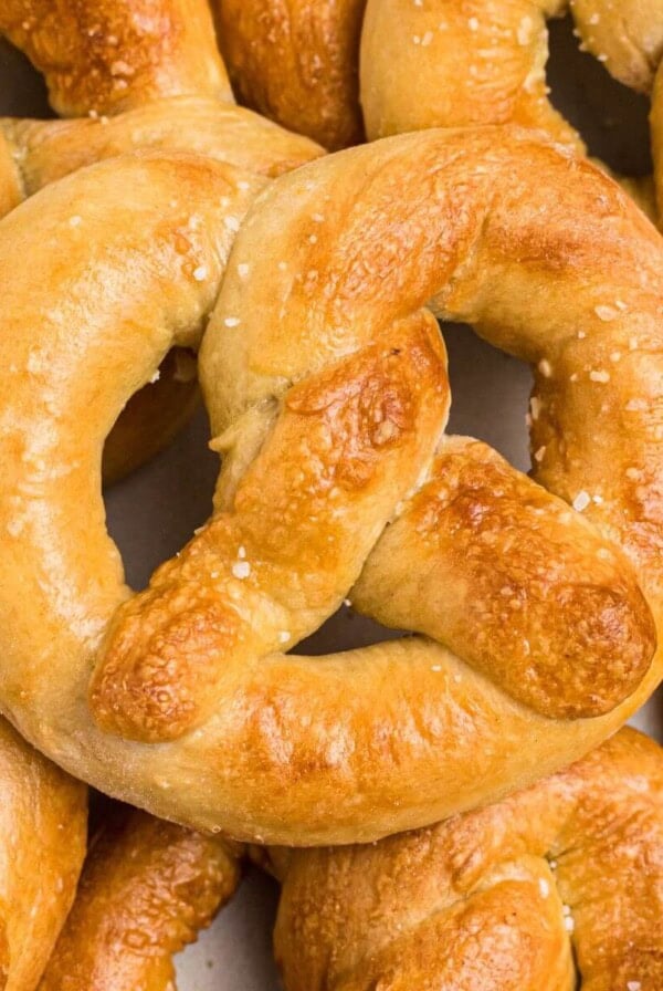 Golden soft pretzels on a white plate