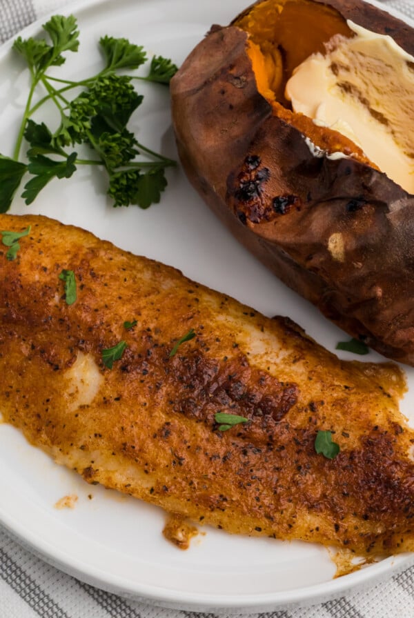 Blackened Air Fryer Swai Fish on a white plate.