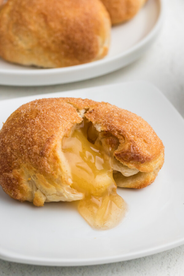 Air Fryer Apple Pie Bomb on a white plate - square photo.