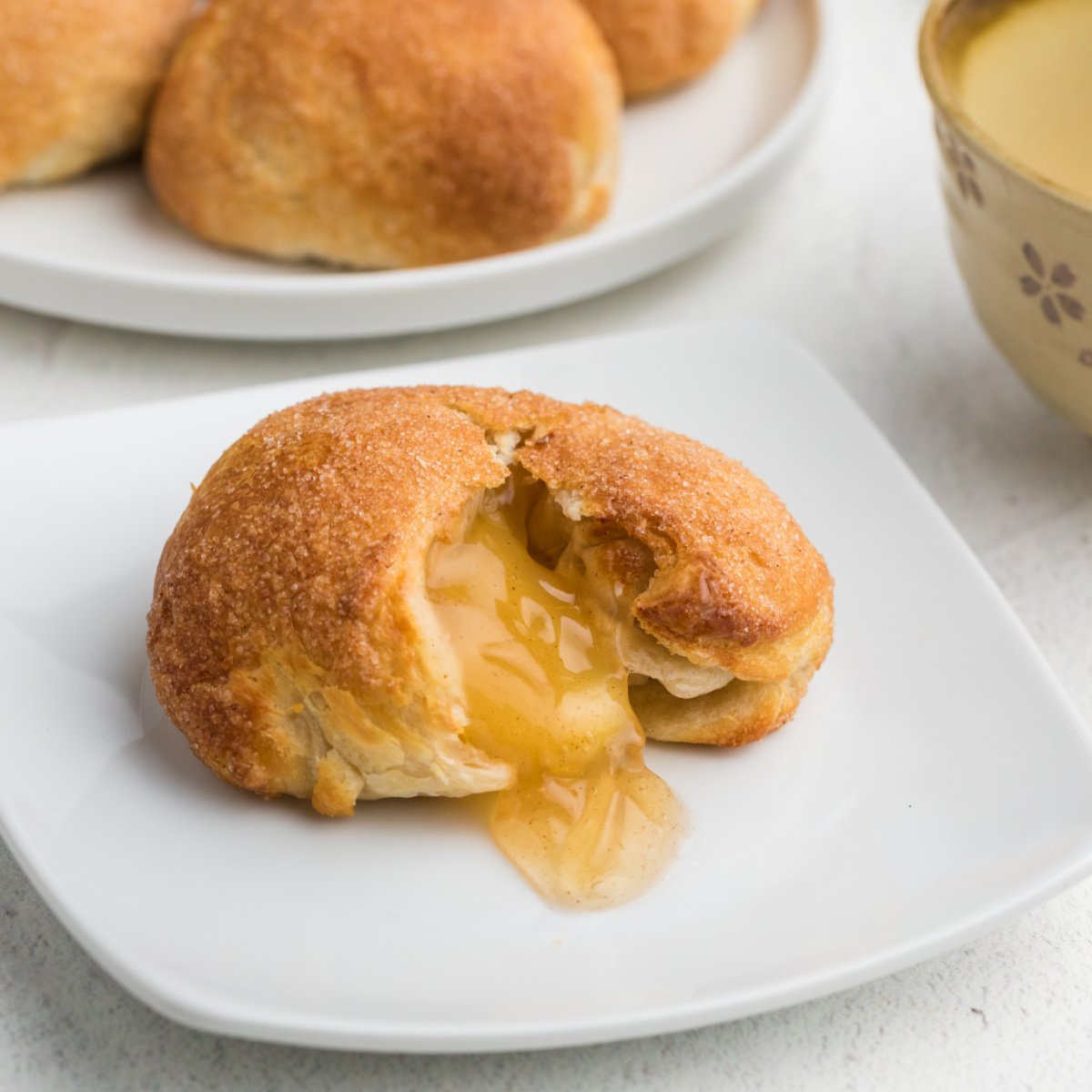 Air Fryer Apple Pie Bomb on a white plate - square photo.