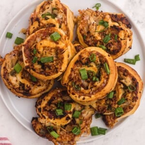 Golden bbq bites with chicken, mozzarella cheese, and topped with green onions.