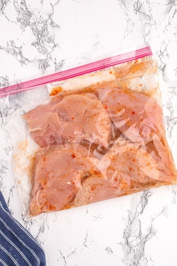 Chicken in a Ziploc bag, sealed and marinating in Italian dressing.