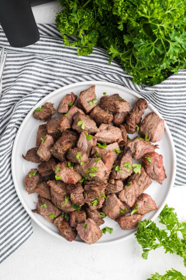 overhead photo of air fryer steak bites on a plate, ready to serve.