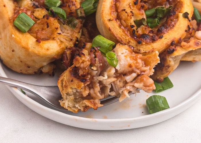 Close up bite shot of pizza roll on a fork. 