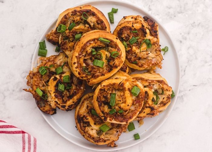 Golden filled rolled crust filled with chicken, cheese, BBQ sauce, and topped with chopped green onions. 