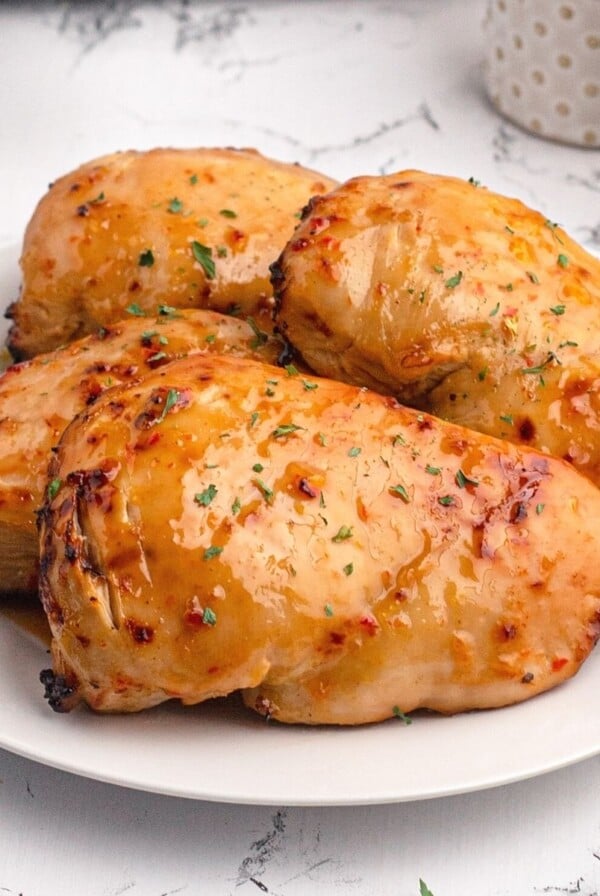 Golden chicken breasts cooked with a shiny glaze of peach preserves and seasonings.