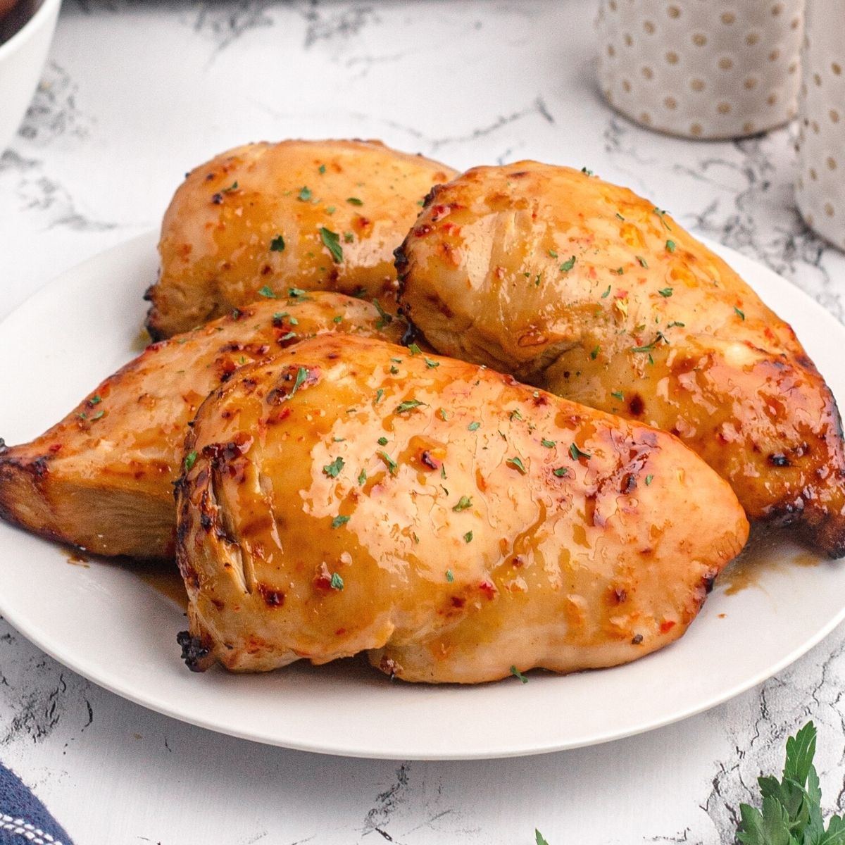 Golden chicken breasts cooked with a shiny glaze of peach preserves and seasonings.