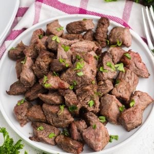 Easy Air Fryer Beef Recipes - a photo of beef tips on a white plate.