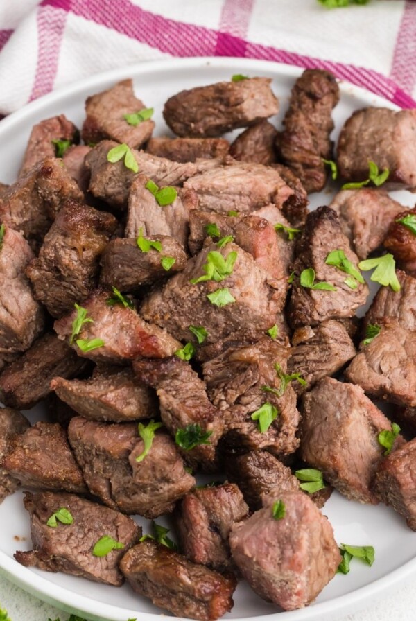 Easy Air Fryer Beef Recipes - a photo of beef tips on a white plate.