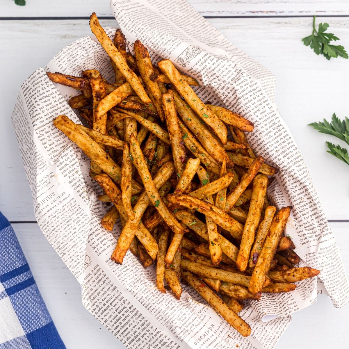 Golden crispy fries seasoned with salt pepper and more.