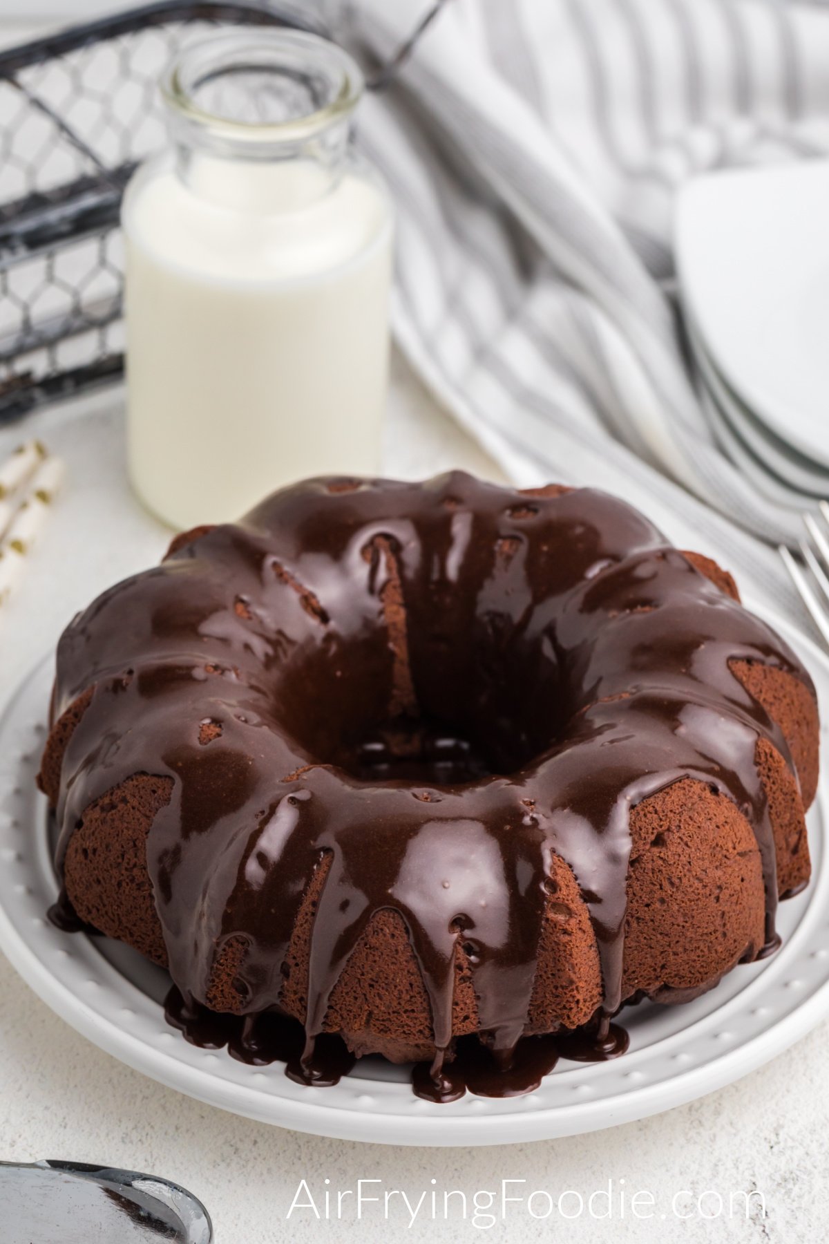 Air Fryer Chocolate Bundt Cake with chocolate frosting ready to slice and serve.