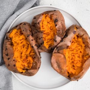 Overhead photo of sweet potatoes on a white plate that were made using an air fryer.