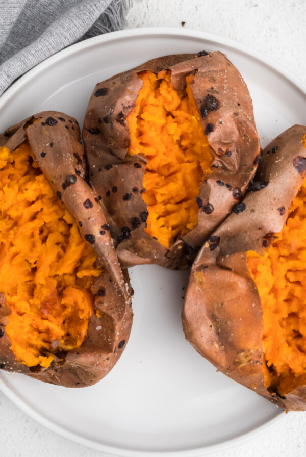 Overhead photo of sweet potatoes on a white plate that were made using an air fryer.