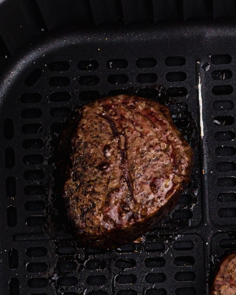 Close up photo of juicy filet after being cooked in the air fryer basket. 