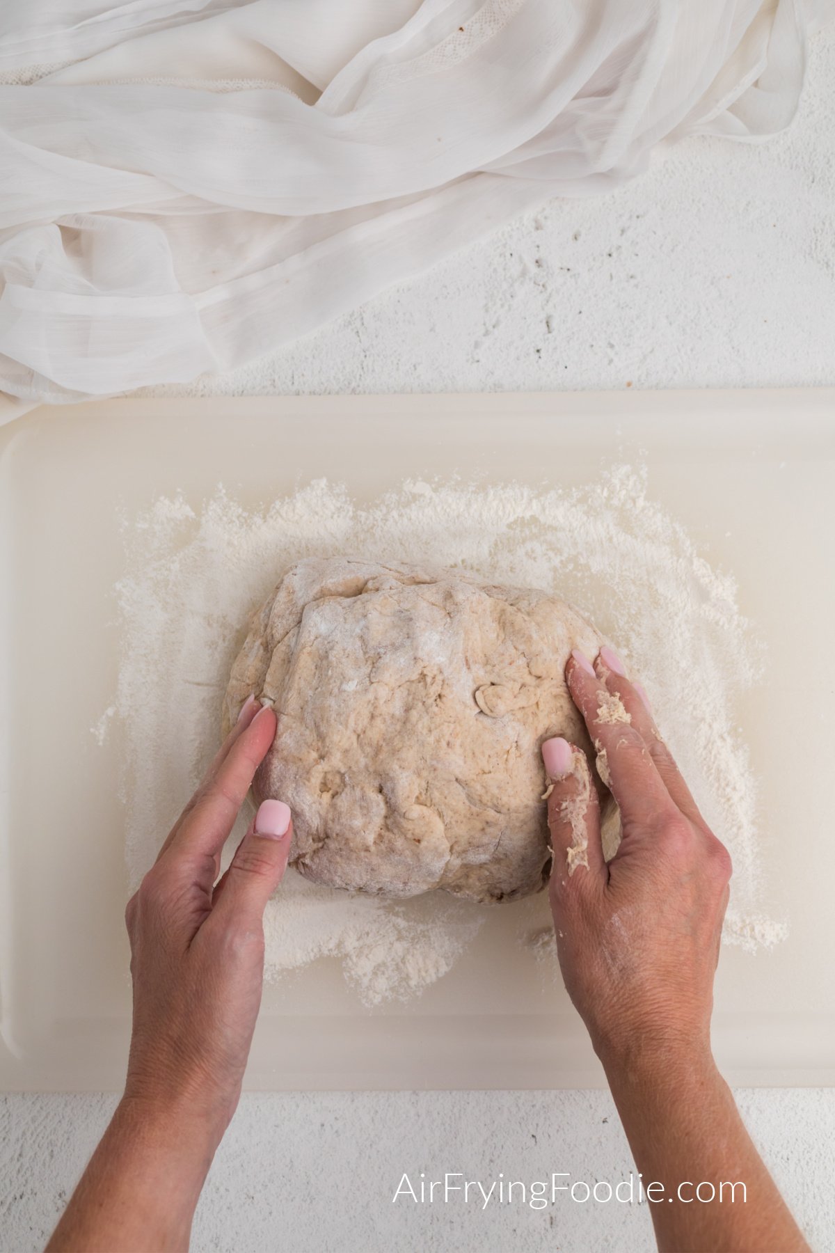 rolling dough on a cutting board with flour