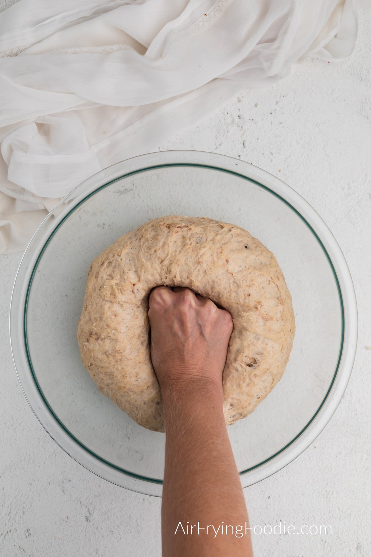 pinching down the dough to make pretzel bites.