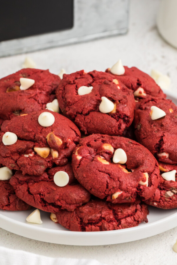 Red Valvet Cake Mix Cookies with white chocolate chips on a white plate.