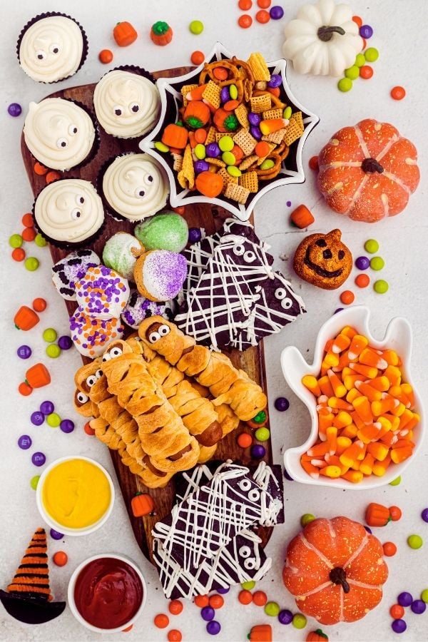 Full photo of charcuterie board with candy scattered around the table