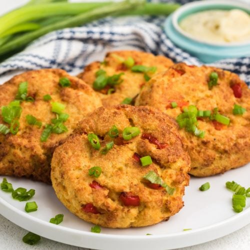 Air Fried Crab Cakes on a white plate garnished with green onion tops.