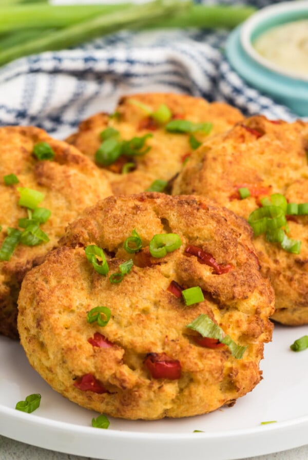 Air Fried Crab Cakes on a white plate garnished with green onion tops.