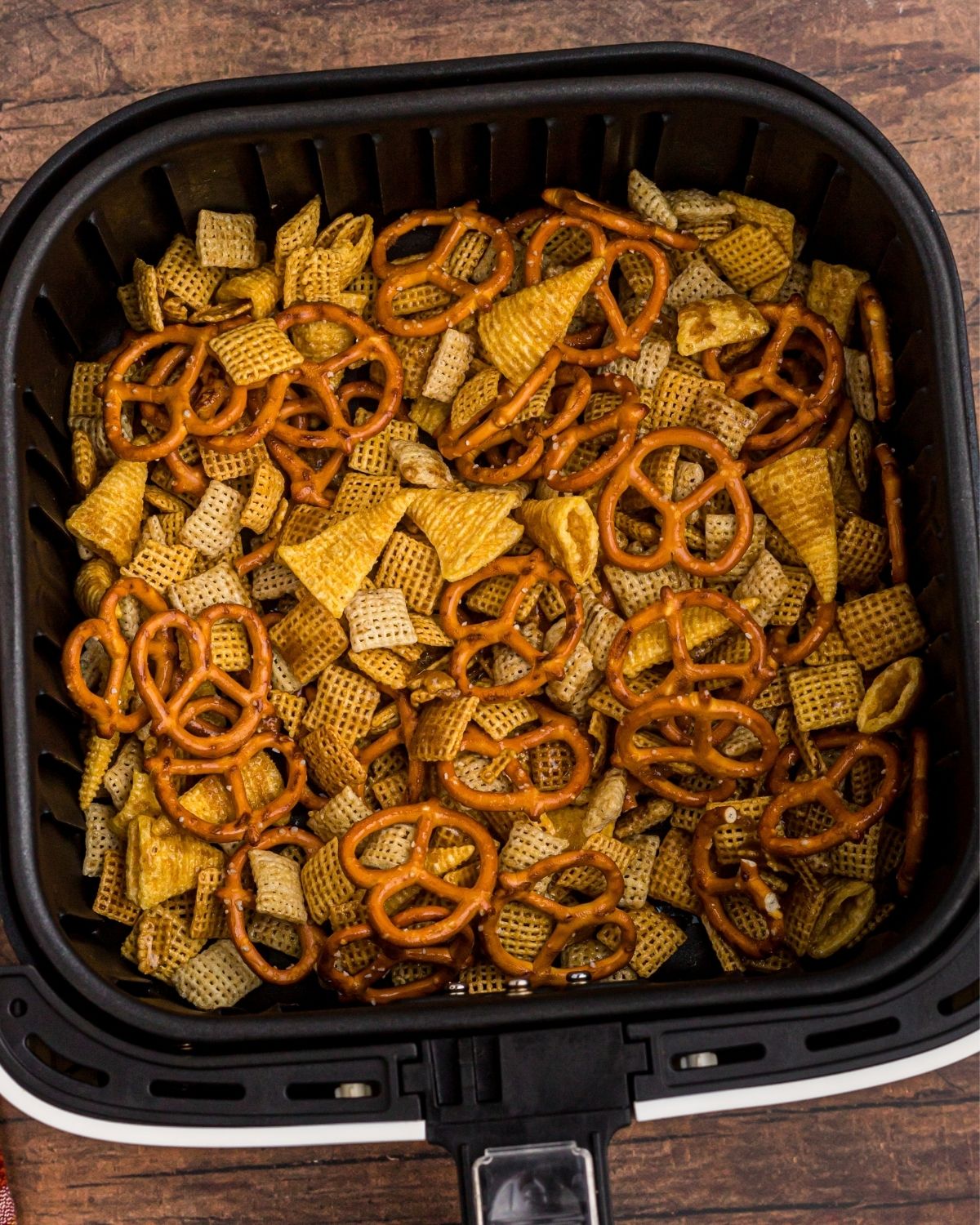 Spooky Air Fryer Halloween Chex Mix 6 Cereal, pretzels, and bugles in the air fryer basket