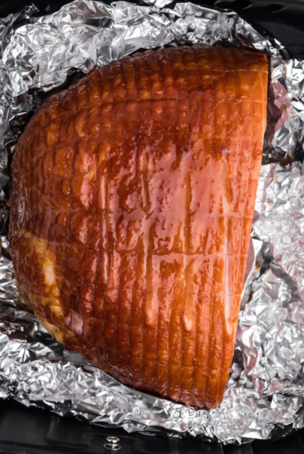 Fully cooked ham in the air fryer basket, ready to eat.