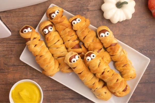 Golden bread crusted hot dogs, wrapped like mummies with candy eyes. 