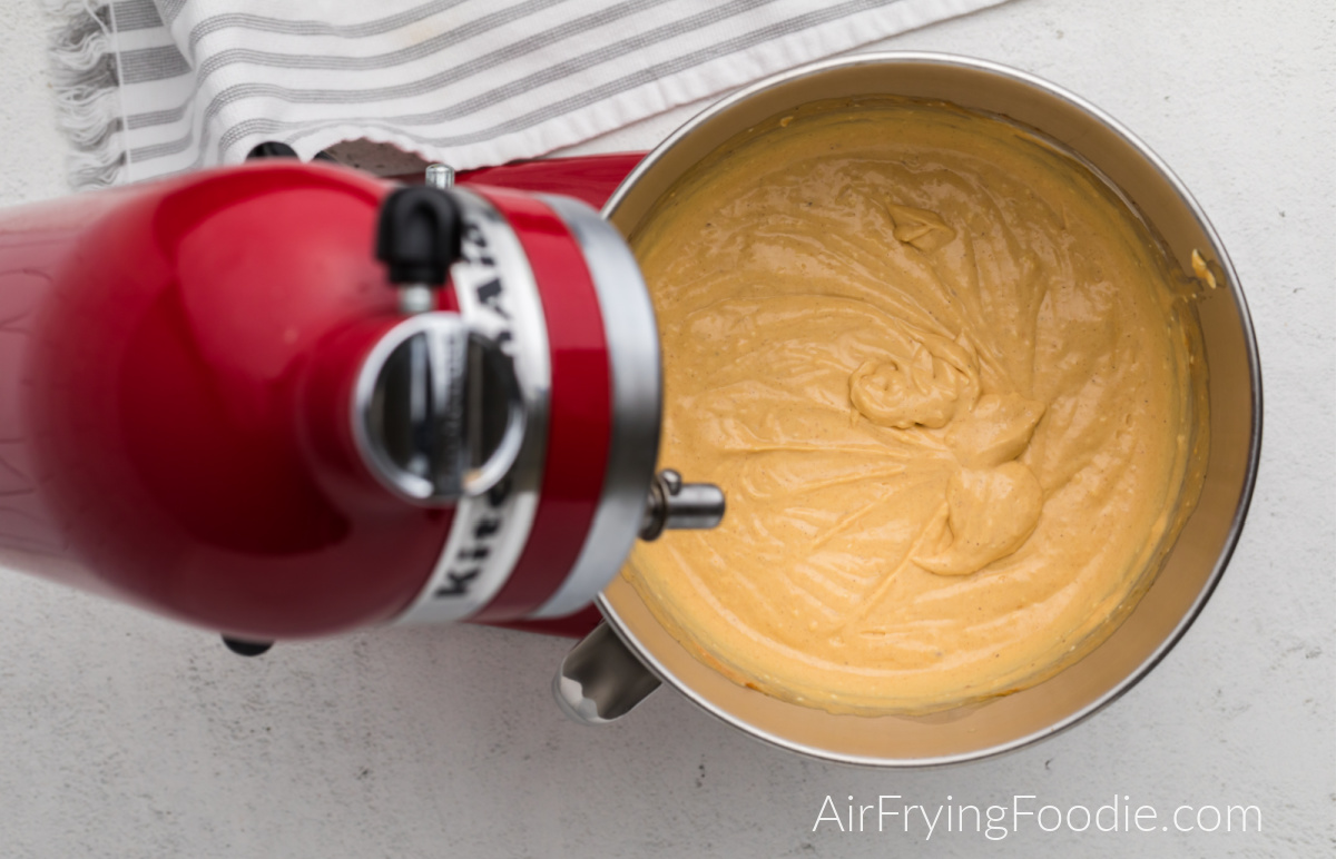 pumpkin cheesecake mixture in the bowl of the stand mixer.