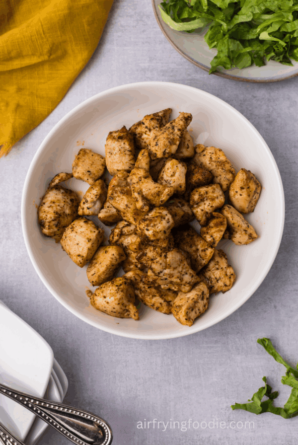 Juicy air fryer chicken bites served in a bowl.