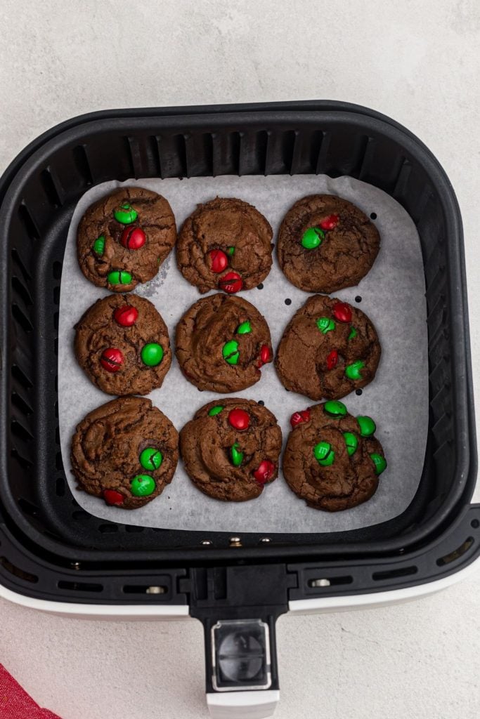Brownie cookies with candies in the air fryer basket after being cooked. 