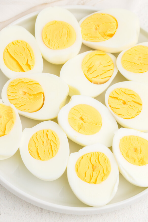 Plate full of air fried hard boiled eggs cut in half.