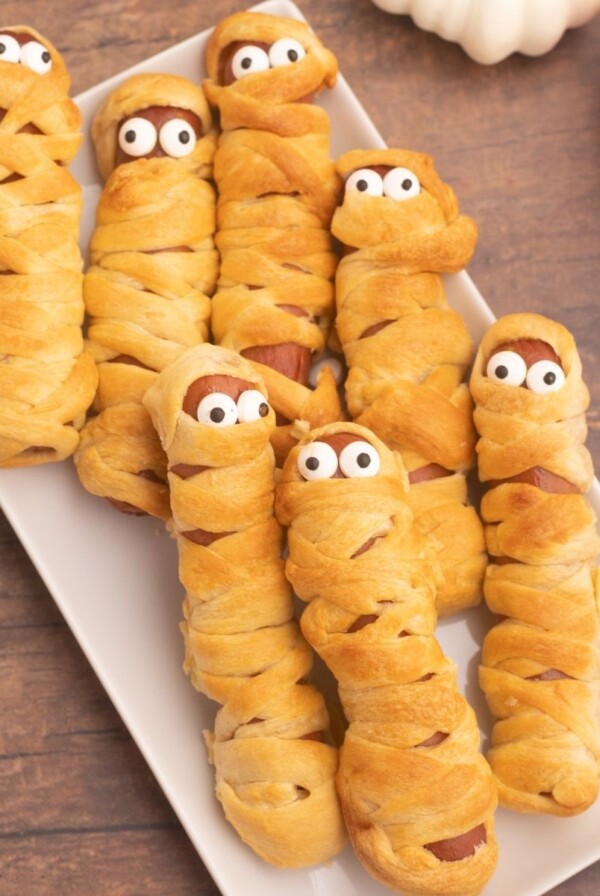 Golden crusted and wrapped hot dogs, to look like mummies with candy eyes