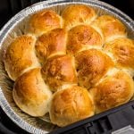 Close up photo of golden rolls in the air fryer basket.