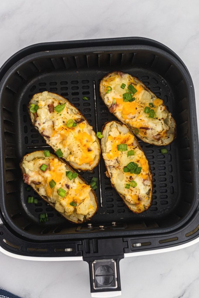 Twice baked potatoes in the air fryer basket after being cooked