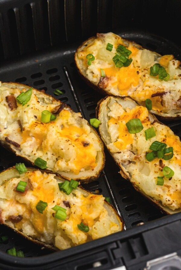 Close up photo of twice baked potatoes after being cooked in the air fryer basket