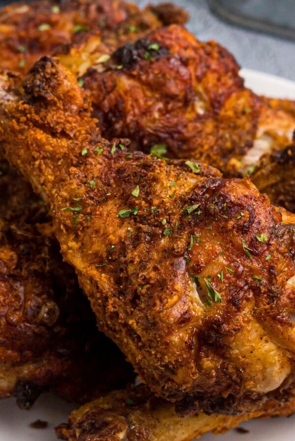 Juicy crusted chicken with seasonings served on a white plate