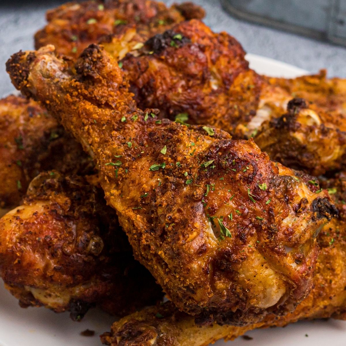 Juicy crusted chicken with seasonings served on a white plate